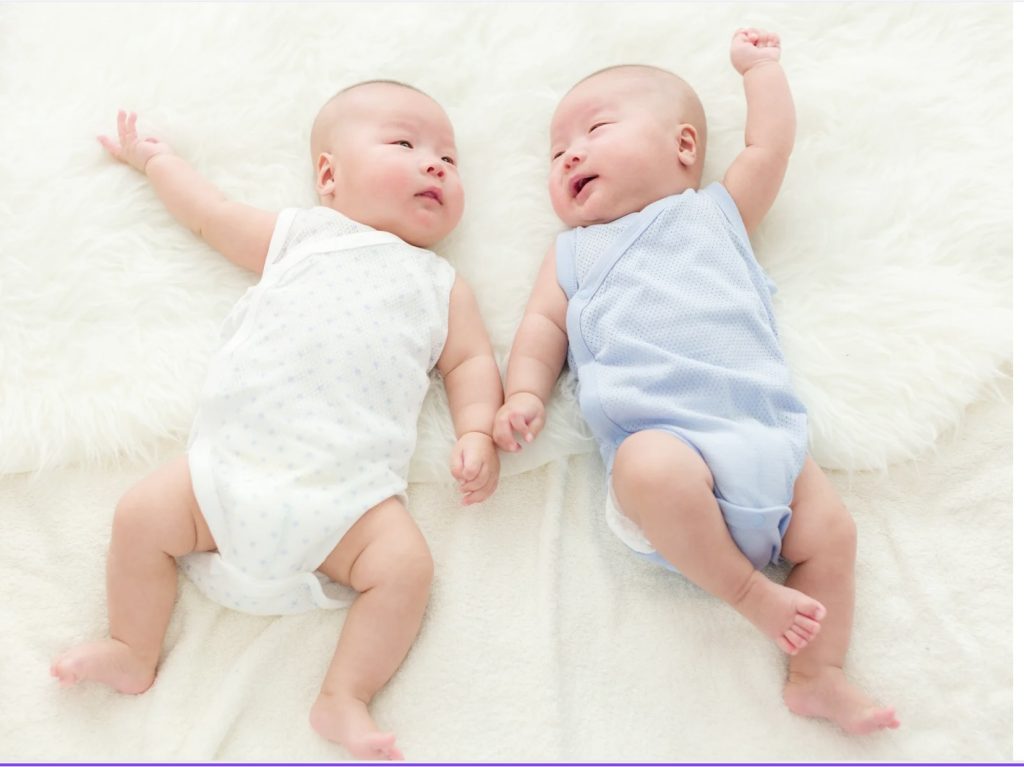 awake and happy newborn twins 